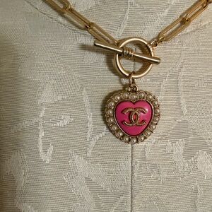 Zipper pull charm on unbranded chain.